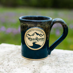 Handmade, ceramic navy with rust color 12 oz mug with Wild Rivers Logo and "Coffee for Conservation" on the center