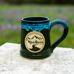 Handmade, ceramic green with turquoise 12 oz mug with Wild Rivers Logo and "Coffee for Conservation" on the center